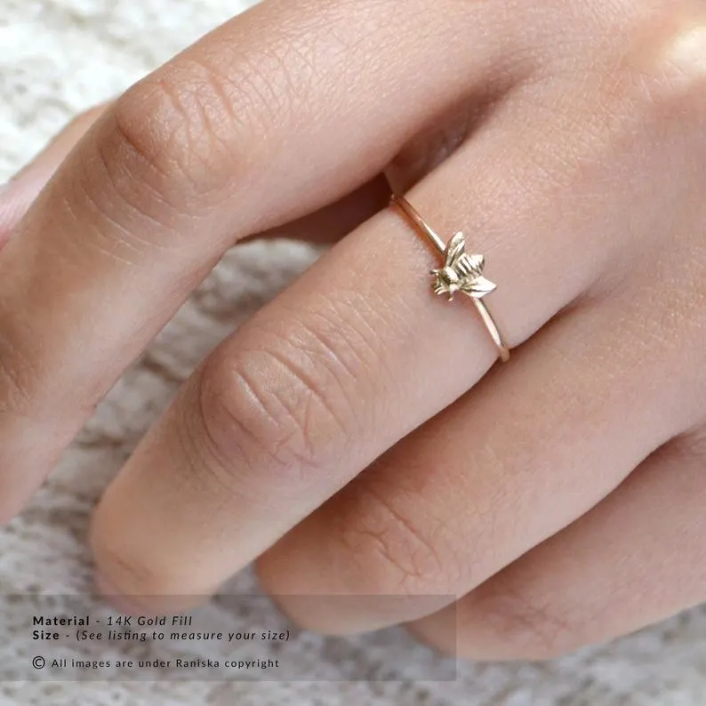 gold bee ring on a finger for a bee gift idea