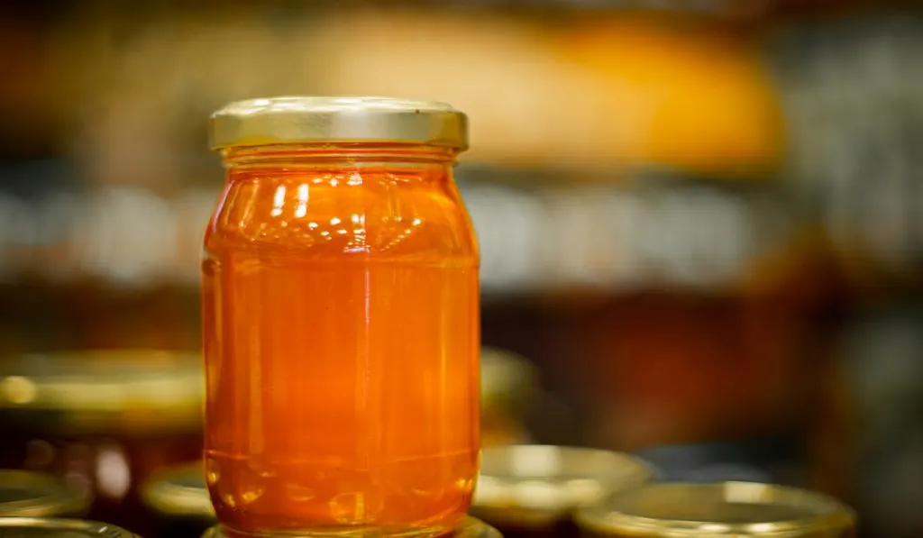 Bottle of a natural honey in  the storage room