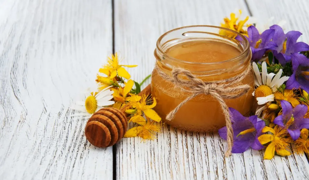 Jar of honey with wildflowers
