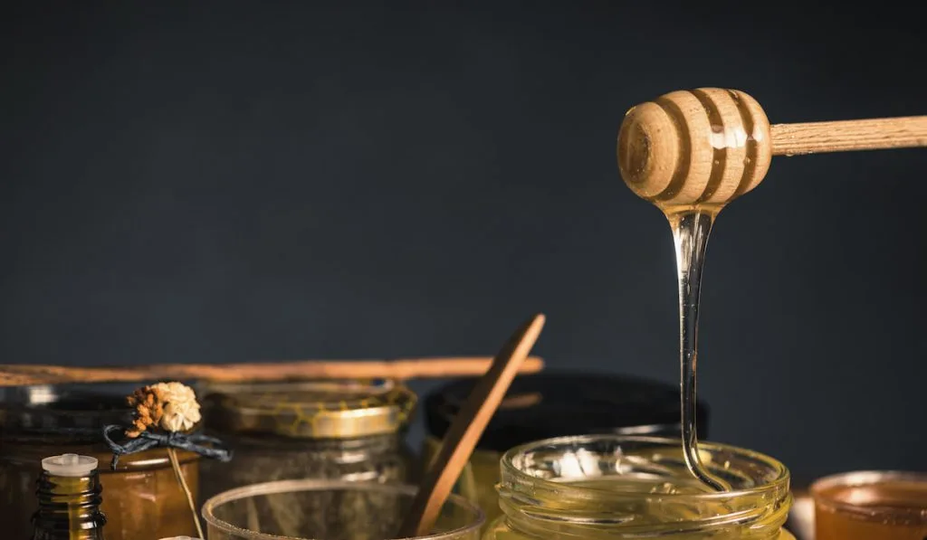 Wooden Dipper with Flowing Honey
