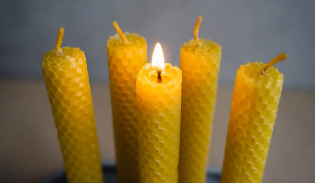 beeswax candles and one candle burning