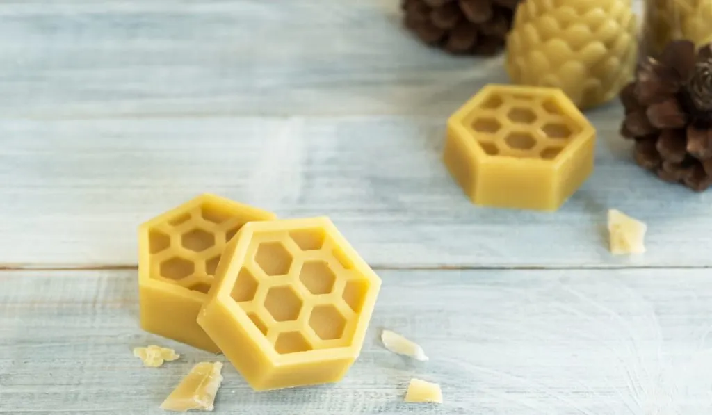 natural yellow beeswax on wooden background