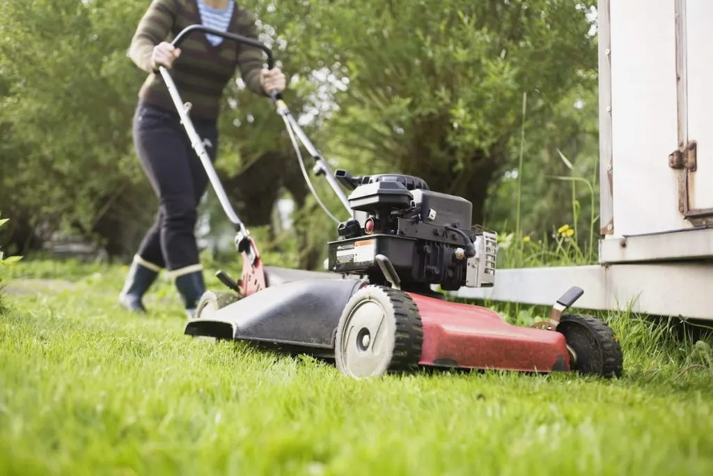 woman mowing lawn